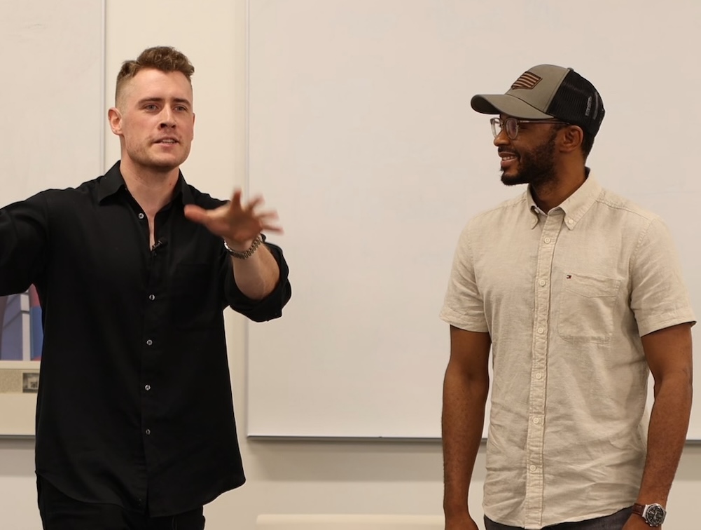 Joseph coaching a participant at the front of the room